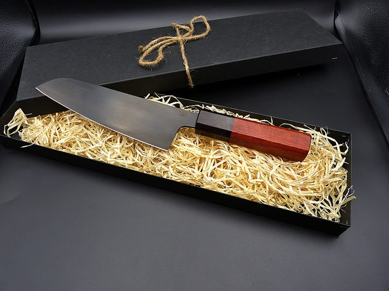 A Santoku made of 1.2235 steel, with a handle of Grenadill and Padouk wood
